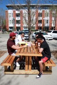 people eating on a bench